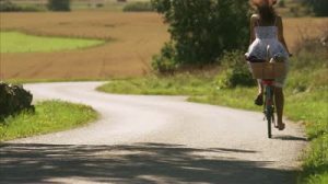 stock-footage-a-woman-riding-a-bike-in-the-swedish-countryside